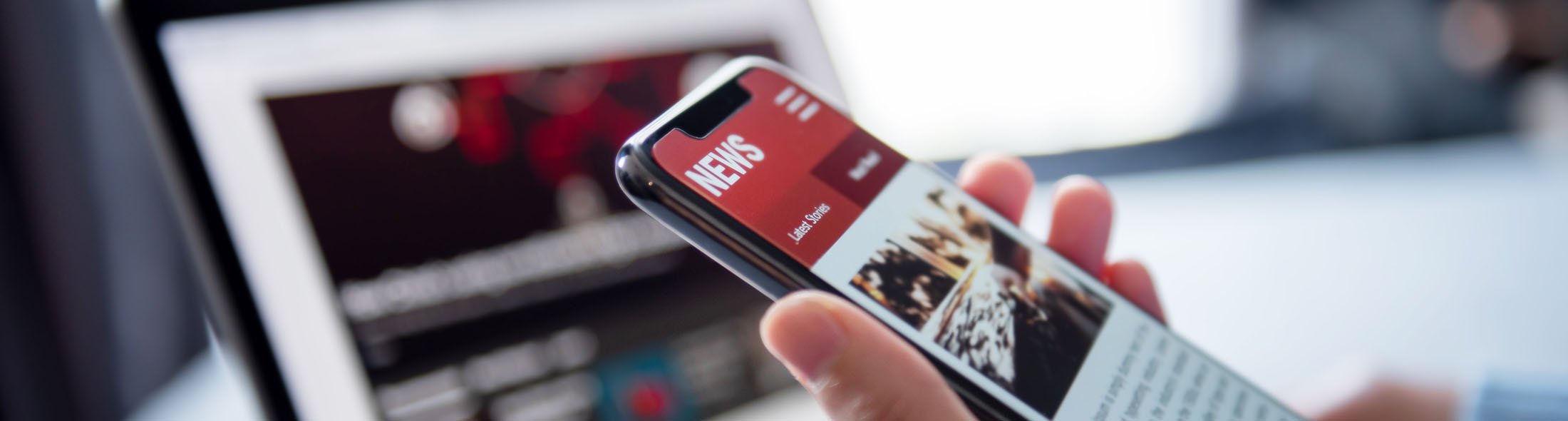 mobile phone with news feed representing NACD news and press releases