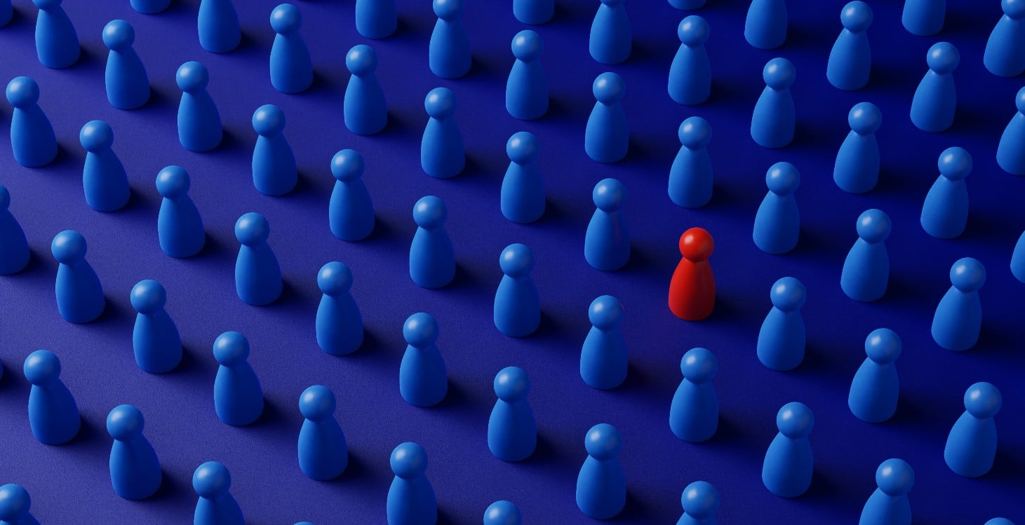 Red figure standing out among a group of blue figures